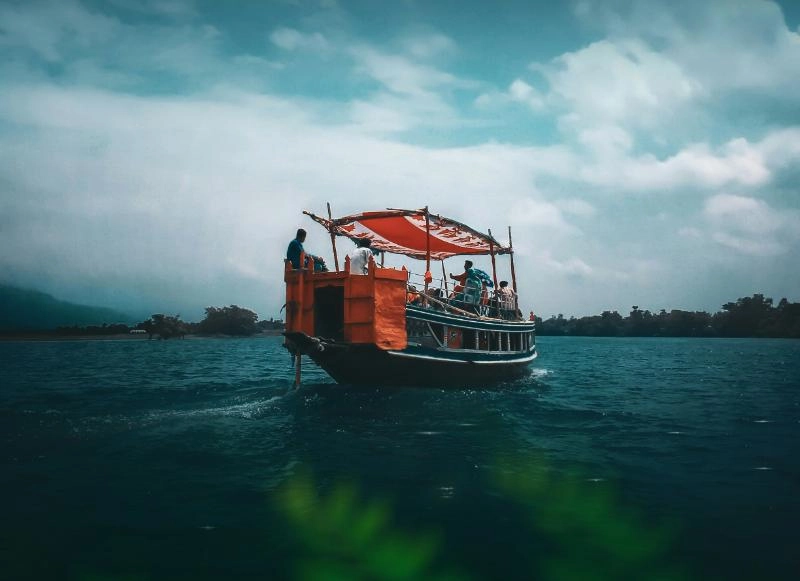 A fishing boat with red sailes in waters of Sylhet, Bangladesh. Image by Ebadur Rehman Kaium, Unsplash.