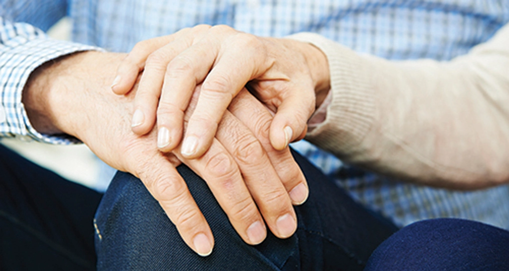 One person's hand resting on top of another's