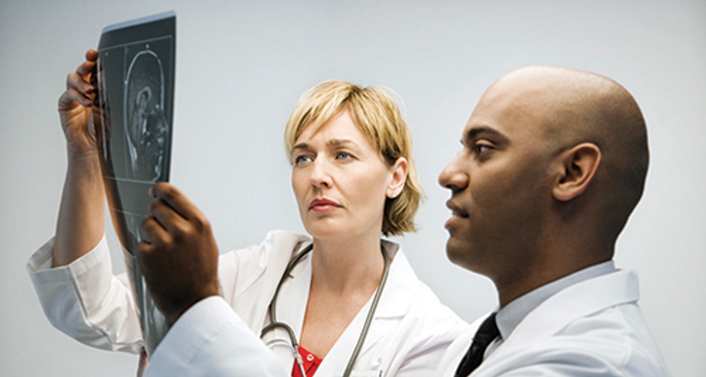 Two doctors looking at a medical chart