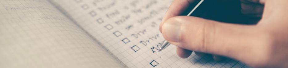 Person writing a checklist