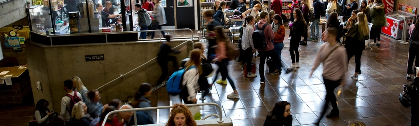 Crowds of students at the café in the Arts Building.