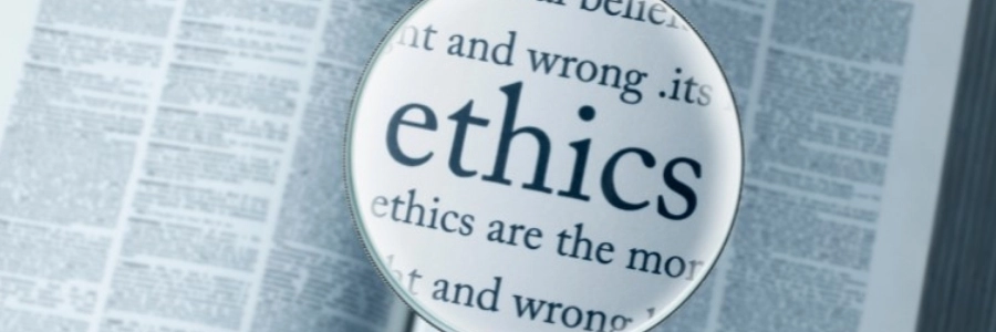An image of a magnifying glass viewing text about Ethics and its definition
