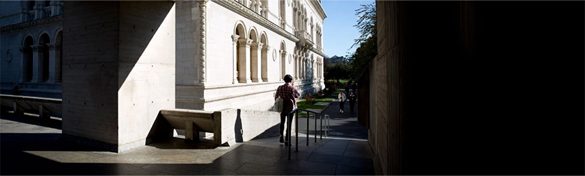 Figure walking from library towards museum building at TCD