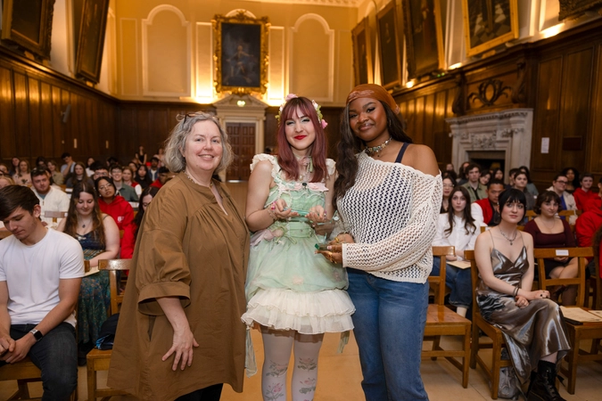provost linda doyle with volunteer alison and promise. alison in green dress at centre of image, promise with white and black jumper on the right.