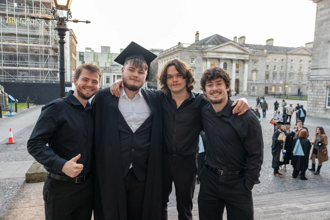 Young men celebrate at college graduation