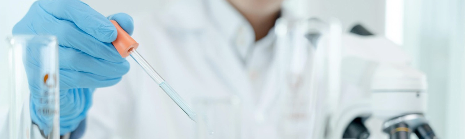 Lab worker holding dropper