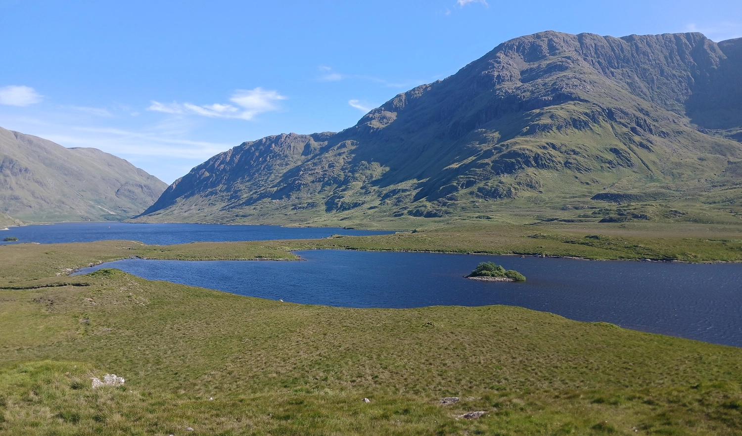 Scenic view or river and mountains, blues and greens.