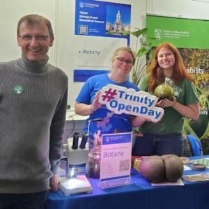 Staff and Students smiling and holding plant specimens at the Trinity Open Day 2024