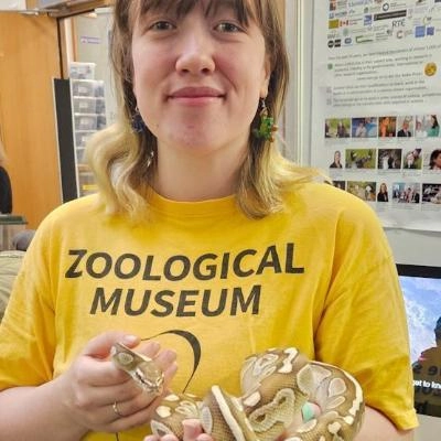 Zoological Museum Volunteer holding small yellow snake