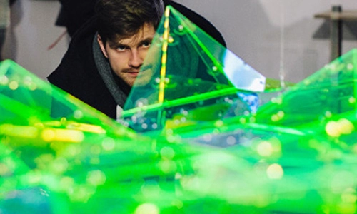 Student looking at a green 3d graph
