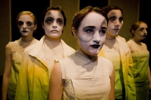 Group of performers with white painted faces