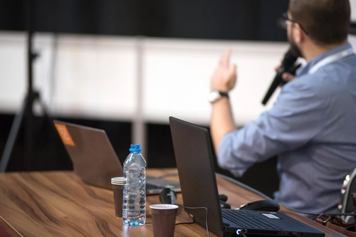 Lecturer at Desk with Laptop