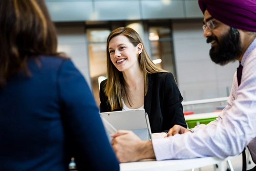 An image of graduates in conversation during a task