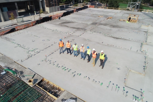 engineerings standing in a line on the foundations of a building