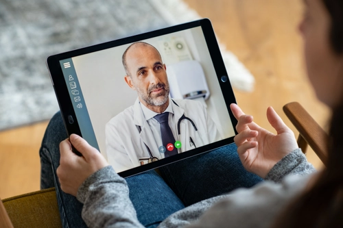 Doctor consulting virtually with a patient on an iPad