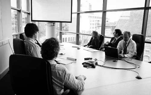 People in a room at a technology Licensing meeting
