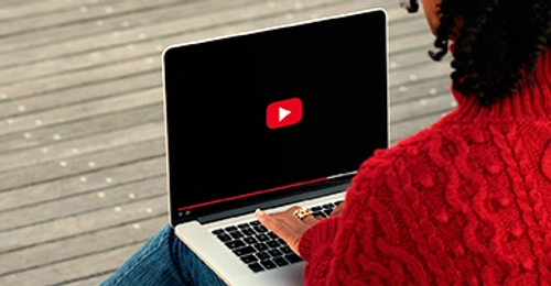 student sitting at laptop screen