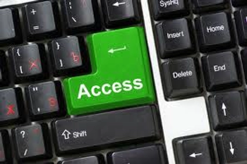 Computer keyboard with green button saying access.