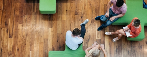 Two sets of students talking to each other from two different benches