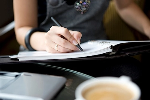 A student writing in a notebook