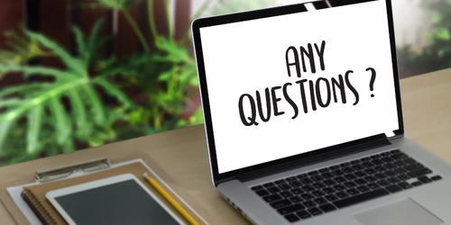 A laptop with Any Questions written on it