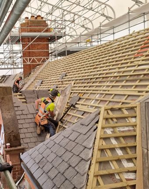 Men fixing roof