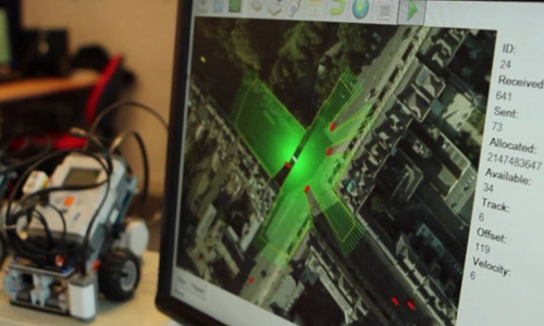 An image of a screen and an autonomous vehicle