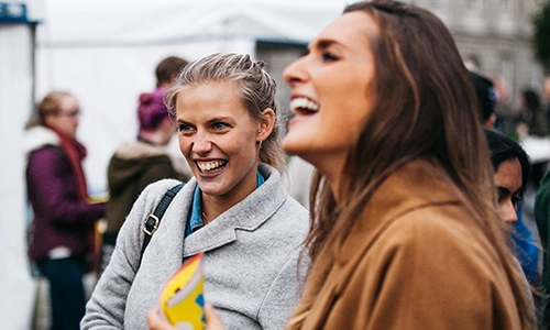 laughing students on campus
