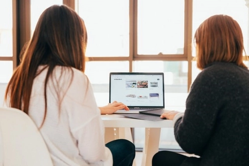 Two people looking at laptop