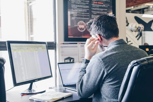 Man at computer screens