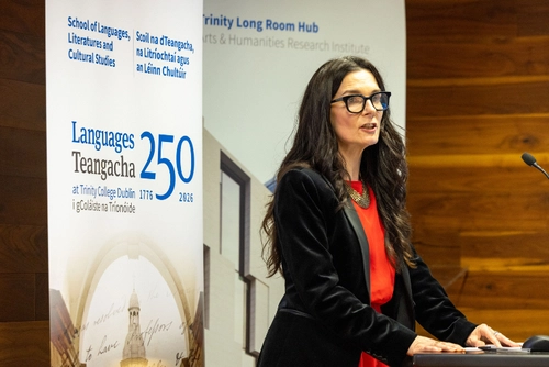Professor Mary Cosgrove standing at a podium at the Opening Ceremony for Languages 250 at Trinity.