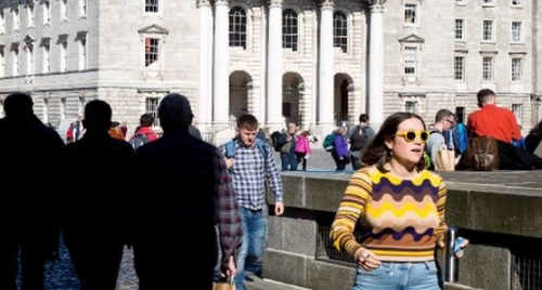 A student walking through campus at TCD