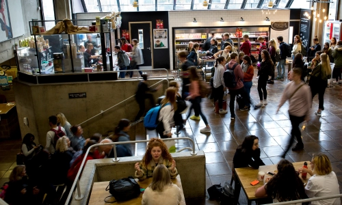 Crowds of students at the café in the Arts Building.
