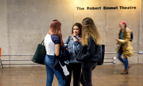 Three students in conversation in the Arts Building.