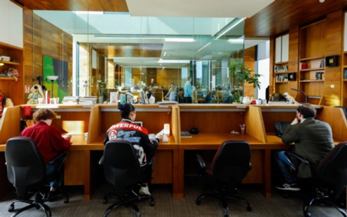 Students sitting at cubicles in the library