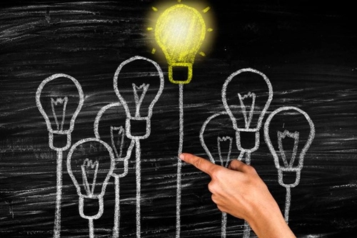 Chalk drawing image of light bulbs the top most fully lit
