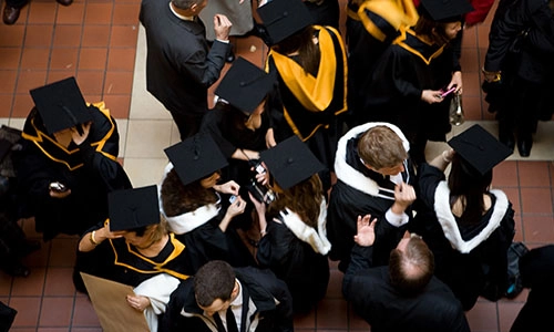 View from above of students at graduation wearing cap and gown