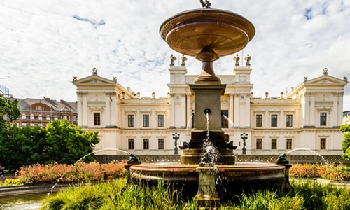 View of campus buildings and fountain of Lund University