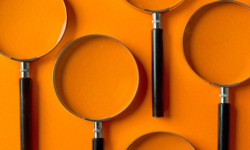 Magnifying glasses on an orange background