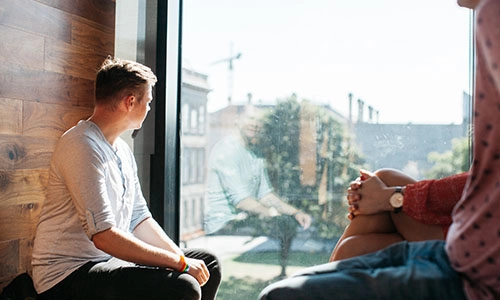 Student sitting at a window in the TCD library