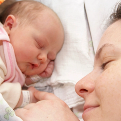 A mother holding a baby's hand