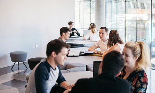 Students collaborating seated at a table in the Science Gallery