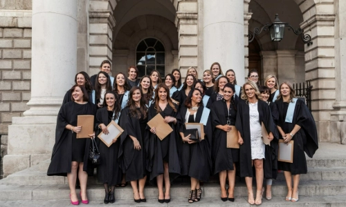 Graduation Nursing and Midwifery class wearing their robes outside the Chapel in Trinity College Dublin