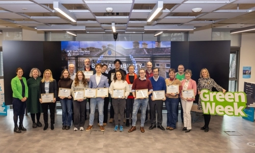 Large group of people in Tangent, all holding framed certificates and smiling for the camera.