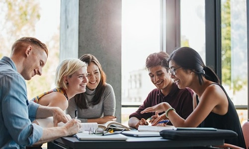 group of postgraduates studying together