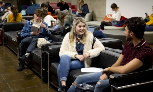 Students chatting outside a lecture theatre in TCD