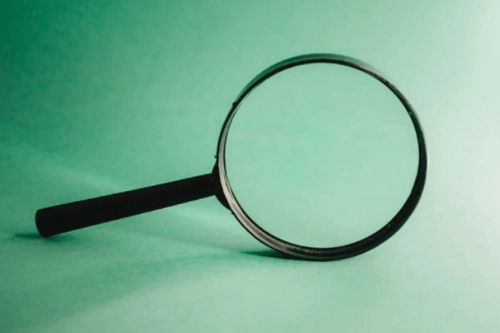 A magnifying glass representing Research Ethics and Integrity