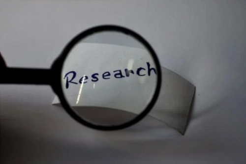 Magnifying Glass looking at the work research