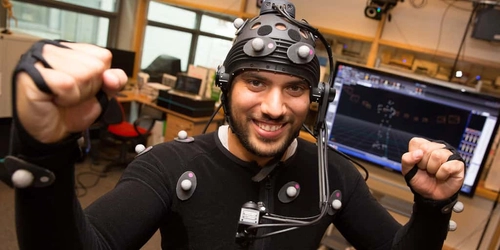 A person in a body suit with data fed into a computer