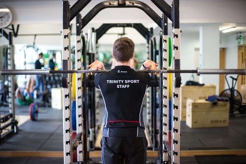 Staff at Sport TCD lifting some weights